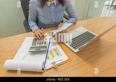 Close-up of accountant hand using calculator in office Stock Photo