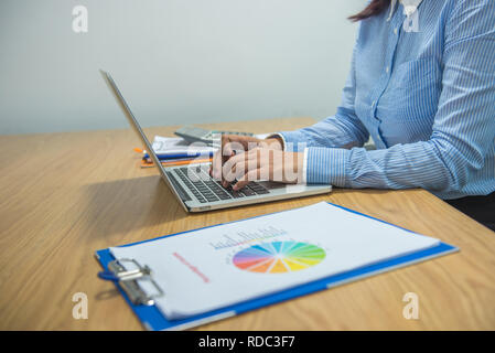 Female hand using laptop in the office Stock Photo