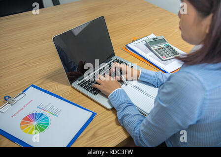 Office lady working on laptop Stock Photo