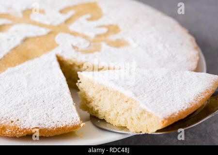 Tarta de Santiago. Traditional almond cake slice from Santiago in Spain on gray background. Close up Stock Photo