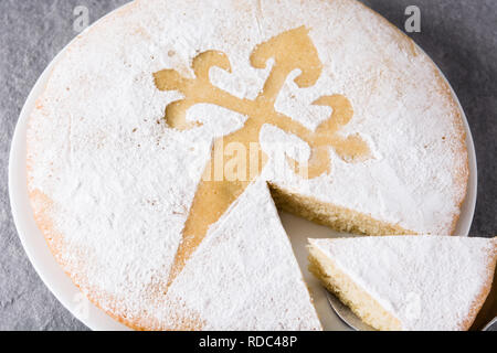 Tarta de Santiago. Traditional almond cake slice from Santiago in Spain on gray background. Close up Stock Photo