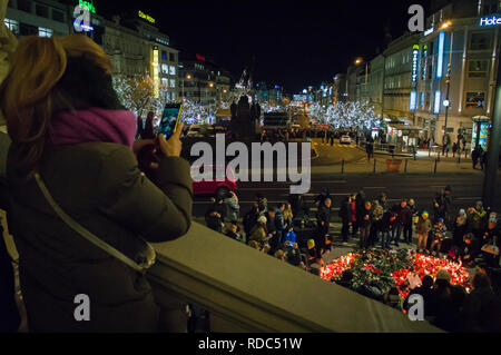 People attend a commemorative meeting at Wenceslas Square and lit up candles at memorial plaque for Jan Palach (right)  at upper part of Square in Pra Stock Photo