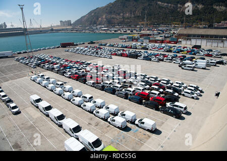 Barcelona, Spain - March 30, 2016: rows of cars on parking in sea port. Car export and import business. Car shipment. Shipping activity. Trade and car commerce. Stock Photo