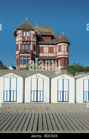 A grand seafront villa behind iconic beach huts at Le Crotoy Stock Photo