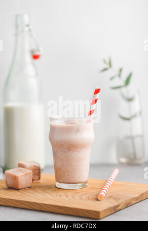 Cold fitness shake is made from milk, protein, cocoa and ice cubes. The concept of a healthy lifestyle and good mood. Stock Photo