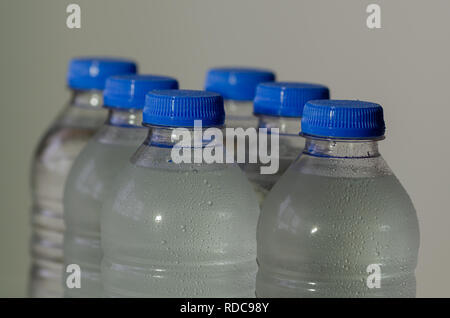 Plastic bottles of water close-up .It is with blue cap bottles. Stock Photo