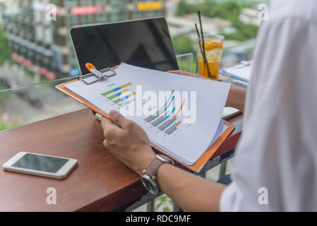 Man hand holding and reading reports Stock Photo