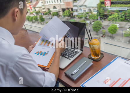 Business employee checking the result on sales reports Stock Photo