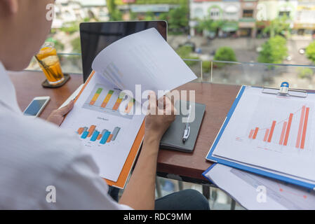 Sales manager sitting at nice working space, analyze sales reports Stock Photo