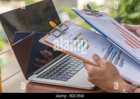 Man hand holding sales reports Stock Photo