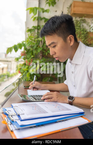 Accountant checking financial number on documents Stock Photo