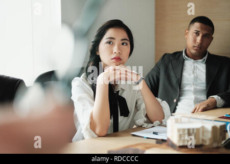 Teamwork With Young Asian Business Woman And Black Businessman Stock Photo