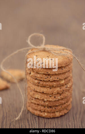 freshly baked chocolate chip cookies on rustic wooden table Stock Photo