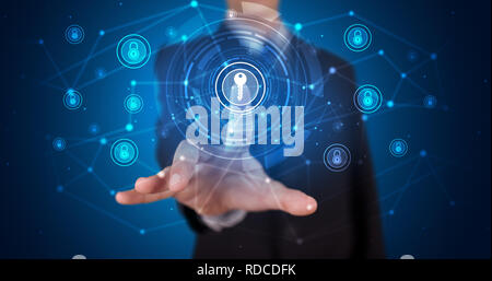 Man touching hologram screen displaying keys and locks Stock Photo