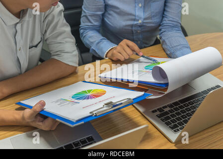 Business team discuss to each other about the financial reports Stock Photo