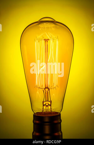 Retro light bulb. The glowing electrodes. Vintage Edison lamp. Ideas are born just when they do not play with the other kids. Stock Photo