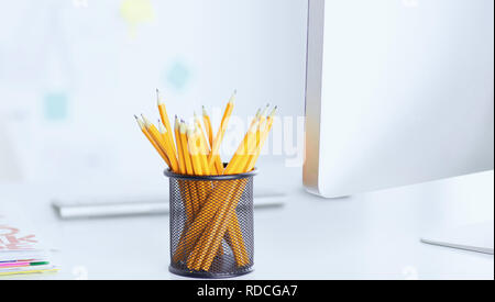 Graphite pencils in a metal grid-container. Concept Stock Photo