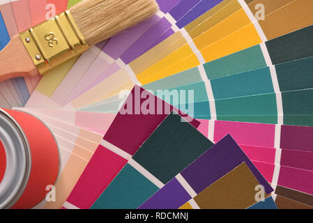 Brush and paint pot on colour chart. Horizontal composition. Top view. Stock Photo