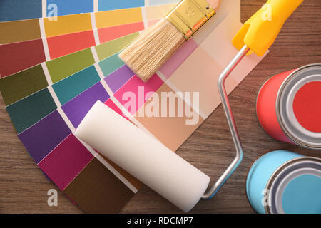 Colour chart pots brush and roller on table top. Horizontal composition. Top view. Stock Photo