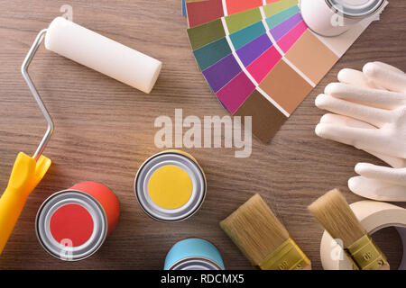 Composition color chart pots and brushes on a wooden table. Horizontal composition. Top elevated view. Stock Photo