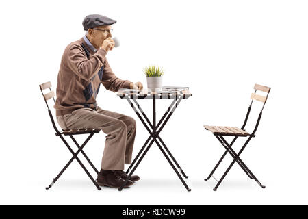 Full length profile shot of a senior man sitting alone and drinking coffee isolated on white background Stock Photo