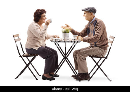 Full length shot of a senior man and woman drinking coffee and talking isolated on white background Stock Photo