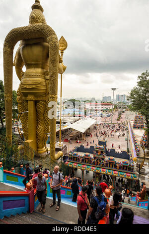 Kuala Lumpur, Malaysia - September 7, 2018: Tall statue of Murugan and vistors can seen exploring the temple, Batu Cave, Kuala Lumpur, Malaysia - The  Stock Photo