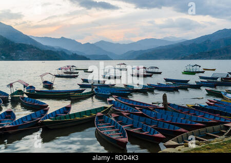 Colorful wooden boats in Phewa Lake at sunset, Pokhara, Nepal Stock Photo