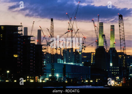 Battersea Power Station, London UK, at dusk, undergoing redevelopment, viewed from the South Bank of the River Thames Stock Photo