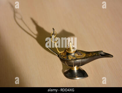Magic genie lamp with shadows on a light background. Magic Aladdin's genie lamp Stock Photo
