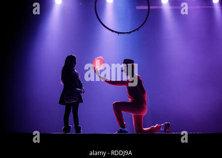 A student wearing a clown uniform seen performing to a little girl on the stage at Rashad Shawa cultural center in part of a show organized by the Gaza stars circus school. This is the first and only school focusing in the circus theatre in the Gaza Strip with 25 students who are part of it. Stock Photo