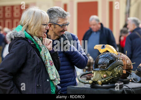 A couple are seen at the annual London Model Engineering Exhibition at Alexandra Palace, north London. Over 50 clubs and societies are exhibiting full spectrum of modelling from traditional model engineering, steam locomotives and traction engines through to the more modern gadgets including trucks, boats, aeroplanes and helicoptersÊwith nearly 2,000 models constructed by their members. Stock Photo