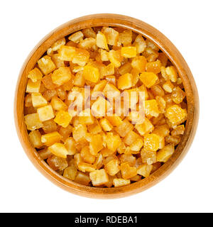 Candied orange peel in wooden bowl. Diced, preserved and crystallized peel of oranges in sugar syrup, often used in cakes as filling. Stock Photo