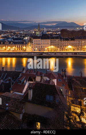 Grenoble, France, January 2019 : City at sunset with isere river and the mountains in the background. Stock Photo