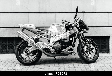 PARIS, FRANCE - JUN 27, 2015: Side view of powerful Aprilia 1000 RSV4 RR sport bike motorcycle made by Italian company Aprilia parked on a street - black and white Stock Photo