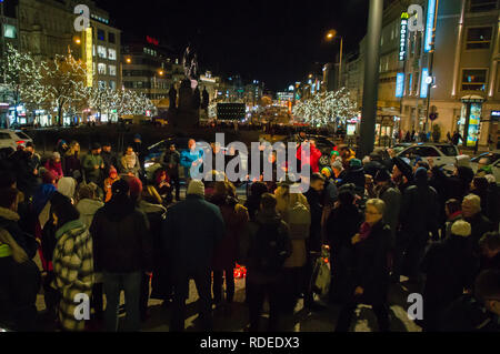 People attend a commemorative meeting at Wenceslas Square and lit up candles at memorial plaque for Jan Palach (front)  at upper part of Square in Pra Stock Photo