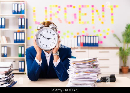 Young employee suffering from excessive work Stock Photo