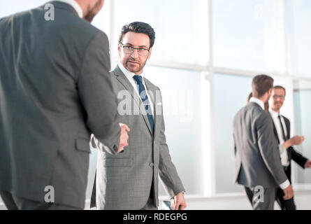 businessmen handshaking after striking deal Stock Photo