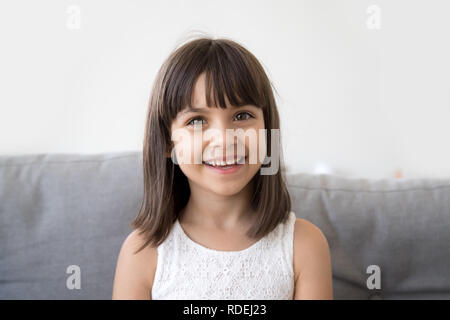 Smiling child girl talking to camera making video call vlog Stock Photo