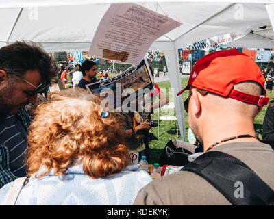 STRASBOURG, FRANCE - MAY 5, 2018: People making a party protest Fete a Macron in front of Gare de Strasbourg - senior couple at promotional politics stand  Stock Photo