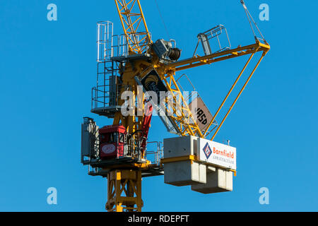 A frame tower crane, seen on almost every major construction site throughout the world. These machines are built to lift heavy loads efficiently. Stock Photo