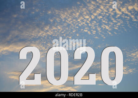 A visual of the year 2020 sitting under a sunset or sunrise, showing the sun has set on 2020 or the sun is rising on 2020 Stock Photo