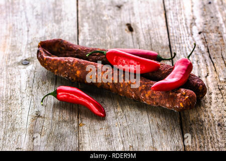 Tapas from spain, chorizo sausage or salami pepperoni, traditional spanish food on wooden table. Stock Photo