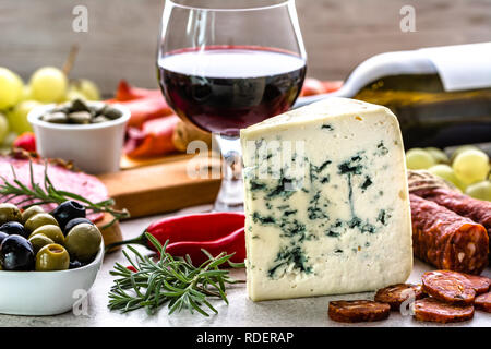 Blue cheese and wine snack set, italian antipasto or spanish tapas bar, selection of food on table in restaurant Stock Photo