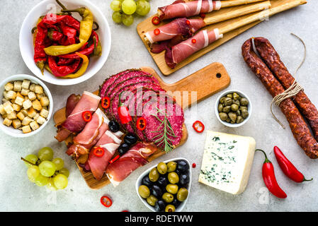 Traditional spanish tapas on table, food selection, cold meat, sausage, spicy chorizo, salami slices, ham and other snack on platter Stock Photo