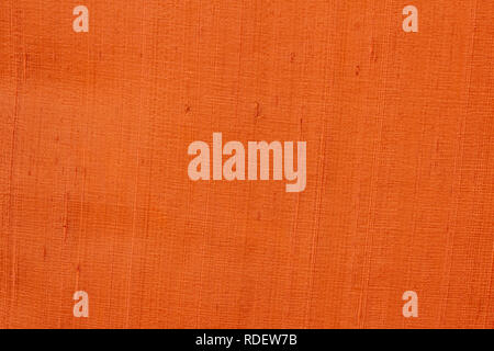 Close up of a woolen fabric of orange-brown color. Abstract canvas background, empty template. Stock Photo