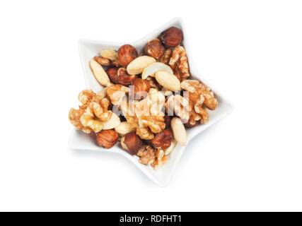 studio shot of mixed nuts isolated against a white background - John Gollop Stock Photo
