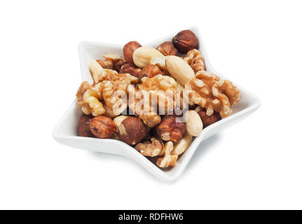 studio shot of mixed nuts isolated against a white background - John Gollop Stock Photo