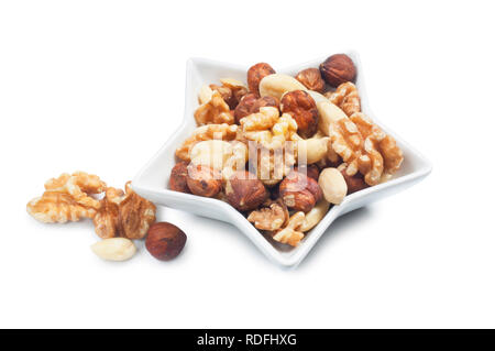 studio shot of mixed nuts isolated against a white background - John Gollop Stock Photo