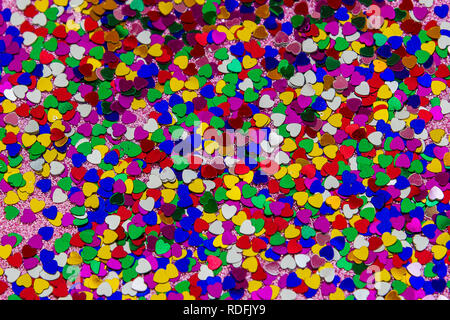 Valentine's Day composition. Flat lay, top view of multicolored, colorful hearts texture. Love concept. Background of small multicolored hearts. Stock Photo